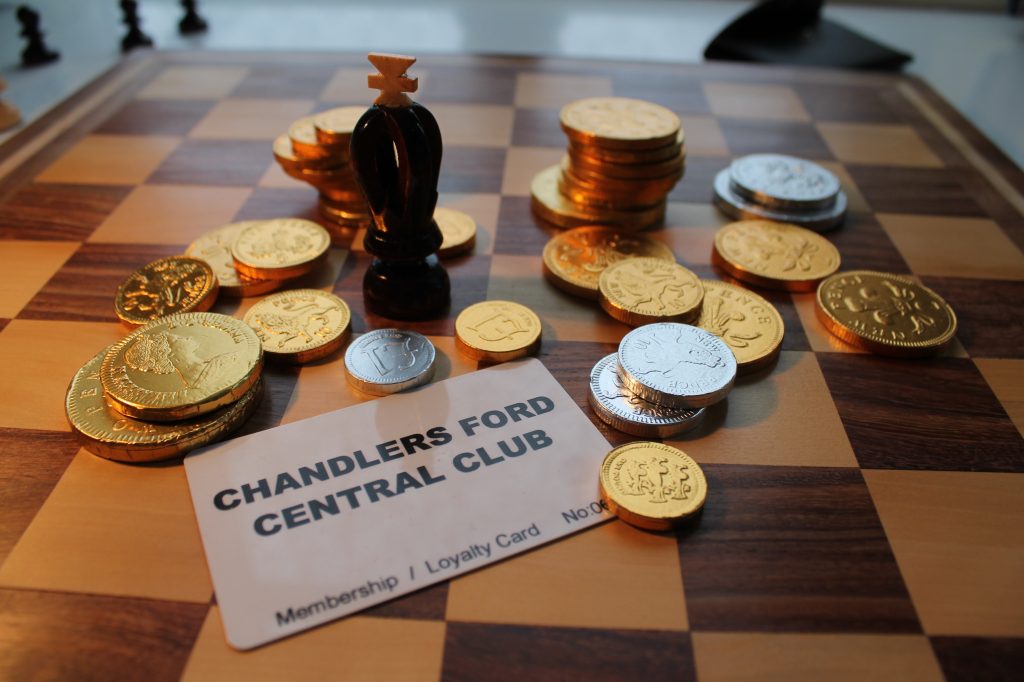 Chandler's Ford Central Club membership card with choc coins on chess board