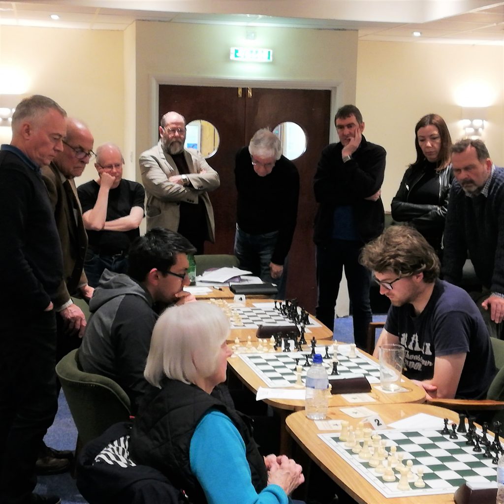 Players gather to watch the end of the Lesniak v Coldwell game.