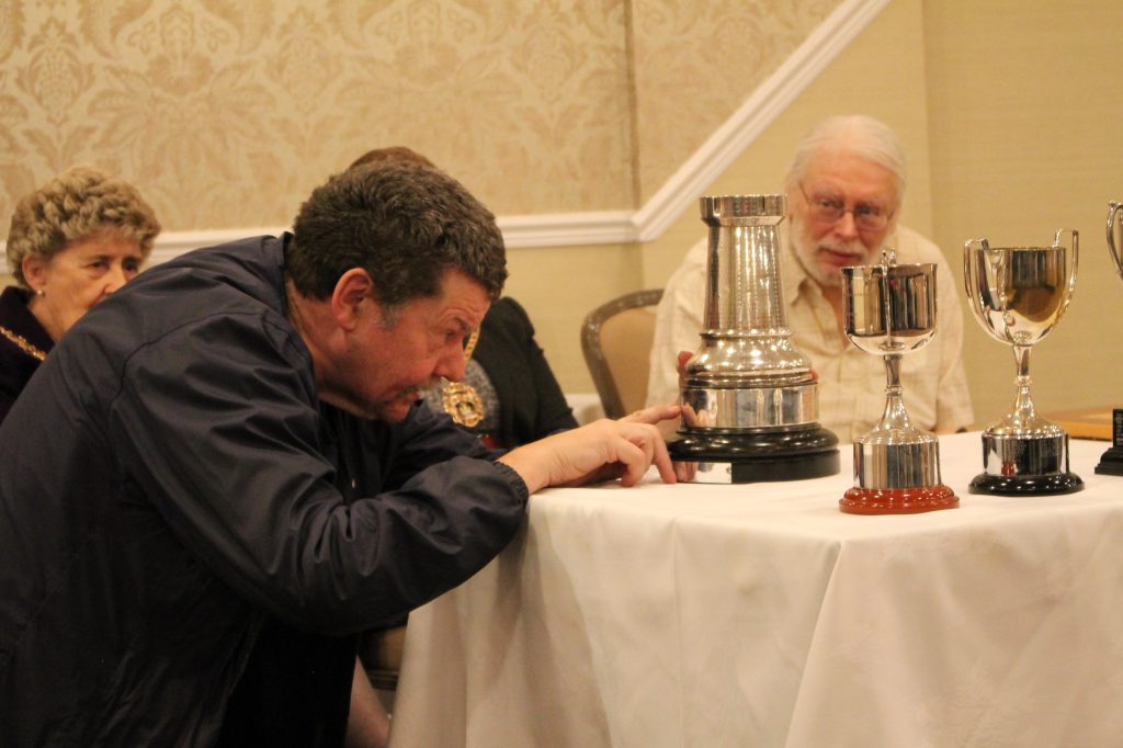 Malcolm Clarke inspects trophy